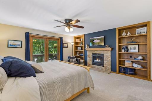 The primary retreat features a gas fireplace, built-ins and private balcony access.