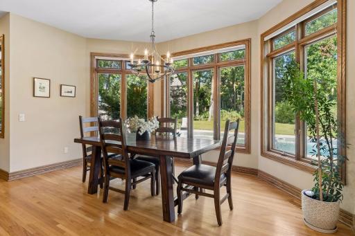 A sunlit dining nook enjoys peaceful views of the private backyard.