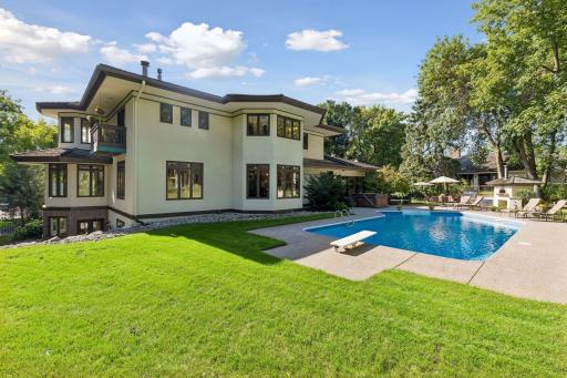 Beautiful backyard complete with an area for yard games, a swimming pool, hot tub and a pizza oven!