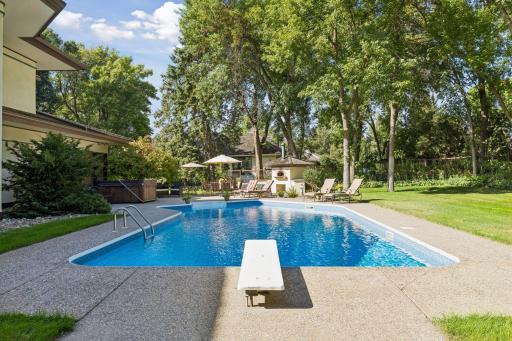 The private backyard transforms into a summer retreat with its sparkling pool oasis.