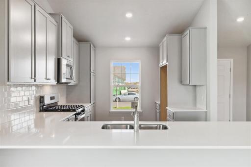 Gorgeous kitchen with lots of storage. Photo of Model Home. Options and colors may vary. Ask Sales Agent for details.