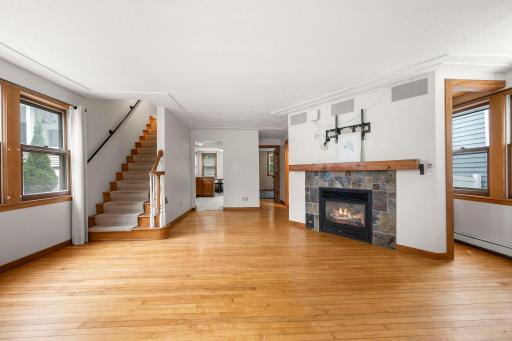 Main floor living room with gas fireplace and newer A/C mini split.