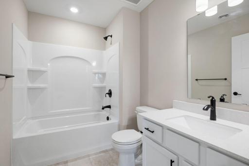 This full bathroom is conveniently located steps from bedroom 2 and the main living area. Features include a single sink and shower-tub combination.