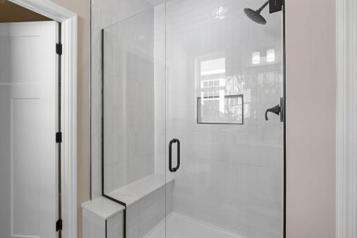 The private bathroom features a glass-enclosed shower