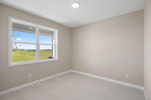 A comfortable bedroom can be found near the front of the home upon entry, steps from a full bathroom for easy access.