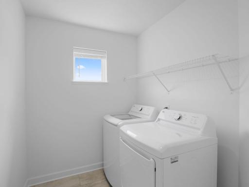 The laundry room features washer and dryer hook-ups and shelving for storage.