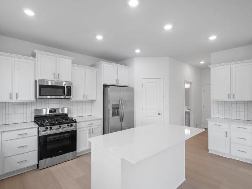 The center island features an overhang with space for counter-height seating