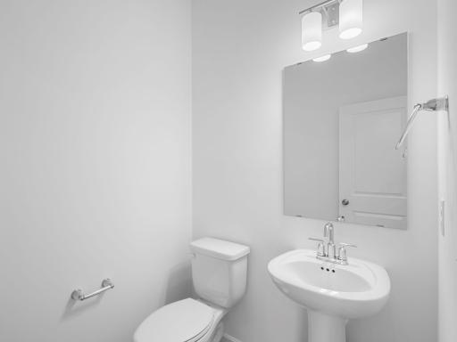 Guests and residents have easy access to a private powder room near first-floor living spaces.