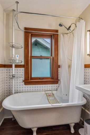 Bath includes new flooring, tile, and sink