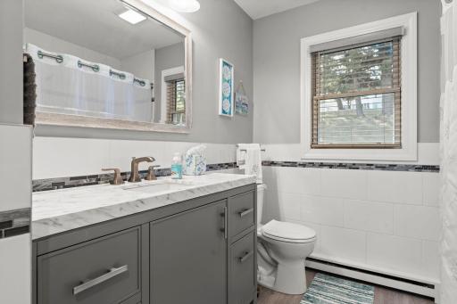 Stylish, modern full bathroom updated with gorgeous tilework, vanity and fixtures.