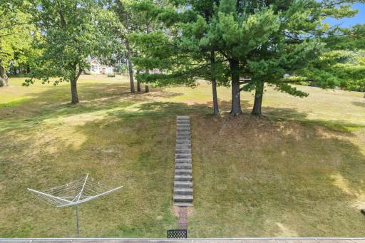 Fabulous backyard setting featuring a picturesque hillside framed by serene, mature treesâoffering beautiful views, natural privacy, and a peaceful outdoor retreat. So much space, steps to a future patio?