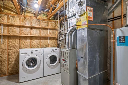 Laundry is in the lower level in the utility room. Photo was virtually cleaned up to remove personal property stored in here.