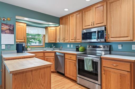 Kitchen features abundant cabinetry, stainless steel appliances and recessed lighting.