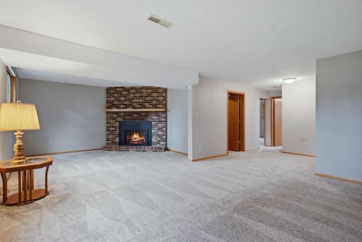 The lower level family room is functional and spacious. The brick corner fireplace is one of my favorite features. The family room also has brand new carpet from Floor to Ceiling.