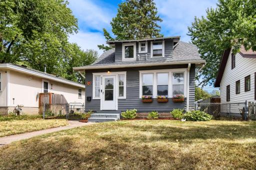 The quaint home features charming front window boxes and a spacious, fully fenced backyard, offering a wonderful outdoor space to relax, play, and enjoy.