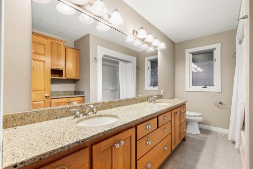 Main floor full bathroom also features Cambria countertops and dual sinks!
