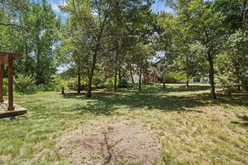 A private backyard retreat with mature trees, open lawn space, and plenty of room to relax or play.