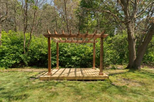 A charming pergola creates a dedicated outdoor space for seating, dining, or entertaining.