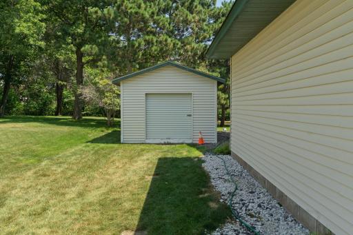 A convenient detached storage shed provides extra space for lawn equipment, tools, and seasonal items.