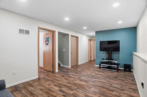 The finished lower level provides easy access to an additional room, storage, and the upper living spaces.