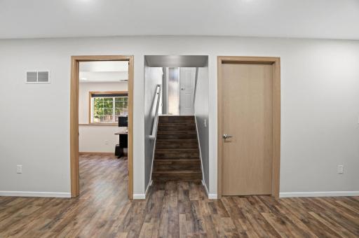 The finished lower level provides easy access to an additional room, storage, and the upper living spaces.