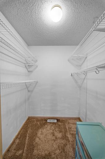 Large walk-in closet with shelving for convenient organization and storage.