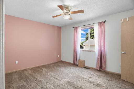 Spacious upper-level primary bedroom with soft natural light and plenty of room to unwind.