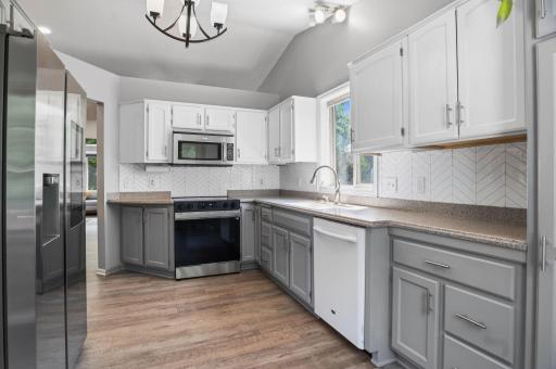 The spacious kitchen offers abundant cabinetry, updated appliances, and a functional layout for everyday cooking.