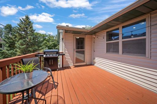 Spacious deck with room for outdoor dining, grilling, and relaxing beneath the string lights.