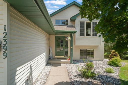A charming covered entrance and low-maintenance landscaping create a warm welcome home.