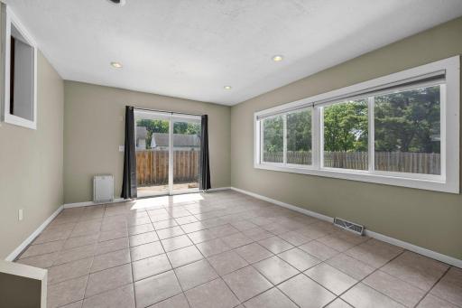 Sun Room / Den With Wood Burning Fireplace & Sliding Doors to Backyard