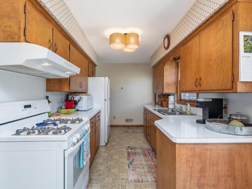Bright white appliances, gas cooking and abundant storage here.