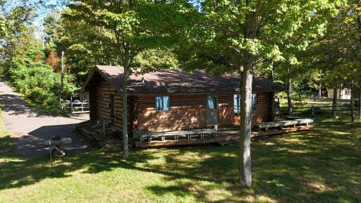 Beautiful log cabin on over 3/4 acre lot with 89' of sandy lakeshore!