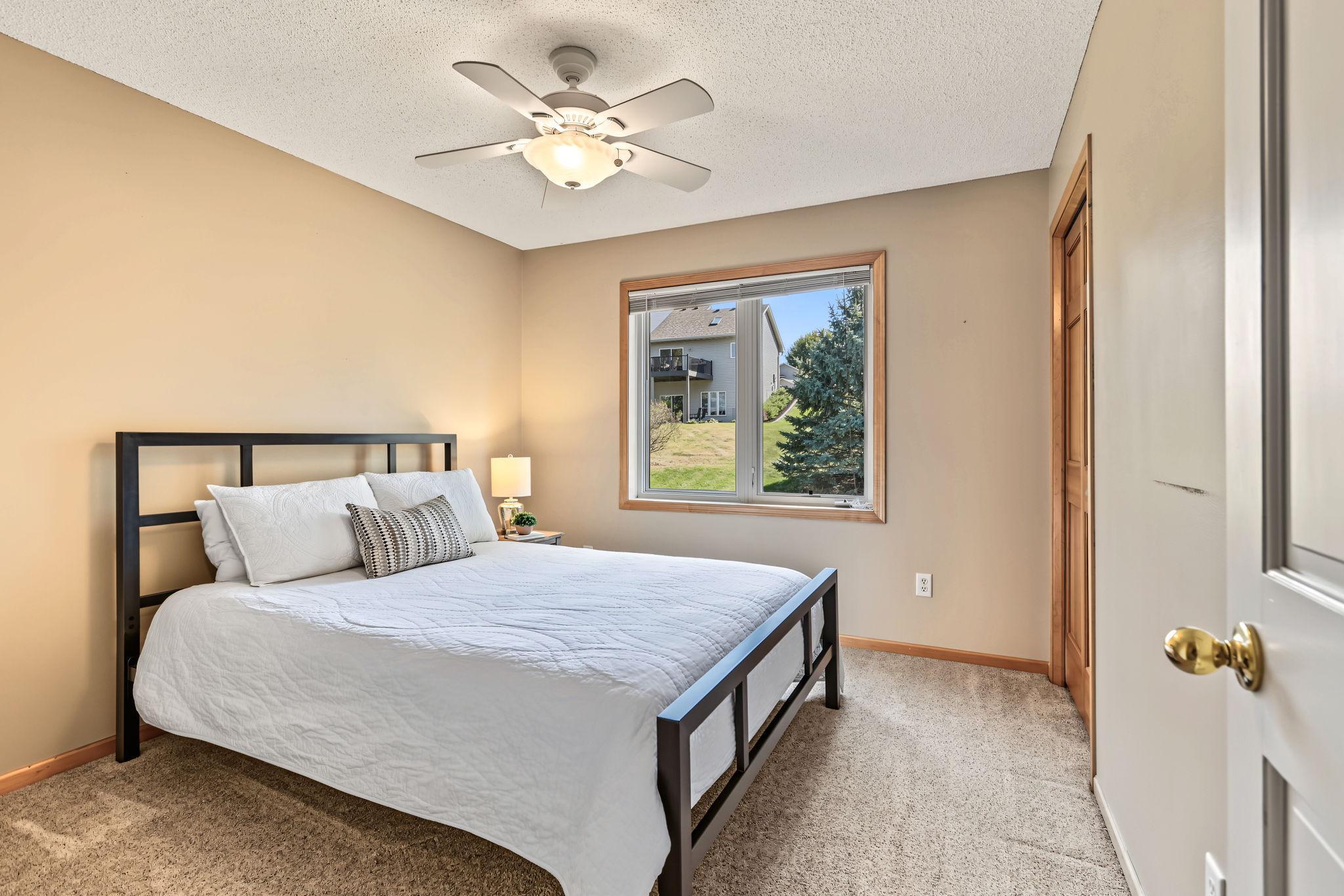 2nd bedroom on upper level with ceiling fan.