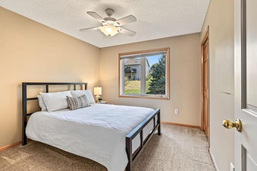 2nd bedroom on upper level with ceiling fan.