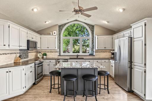 WOW! The kitchen is not only the heart of the home - it truly shines! The stunning custom arched window and beautiful tile surround create a gorgeous focal point, filling the space with natural light and character.