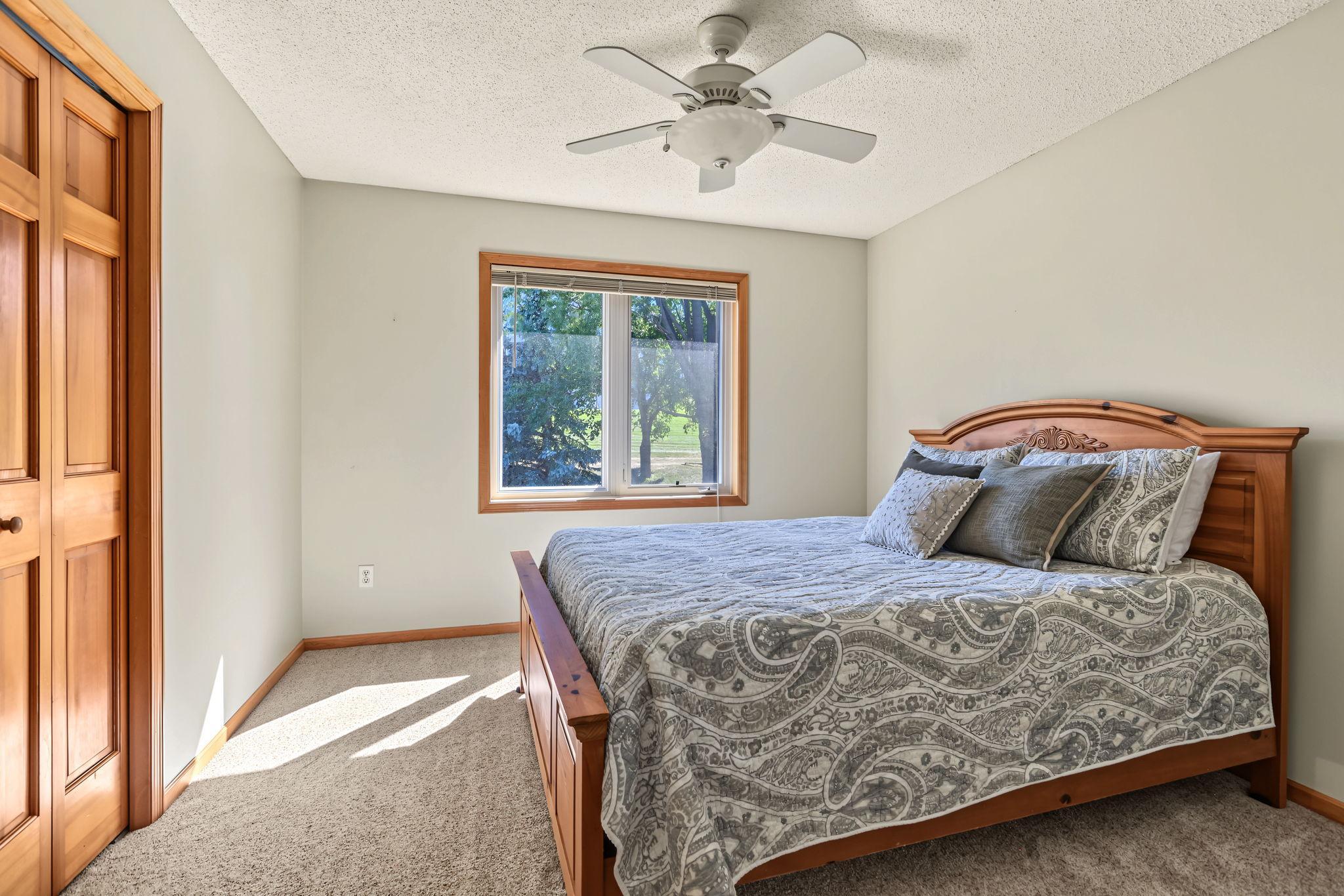 3rd bedroom on upper level with ceiling fan.
