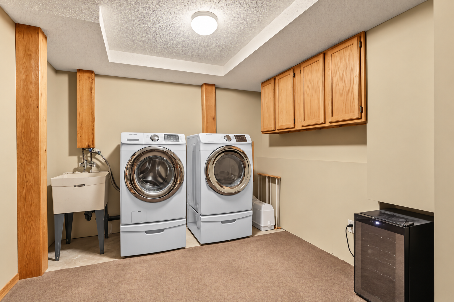 Laundry room offering storage space.