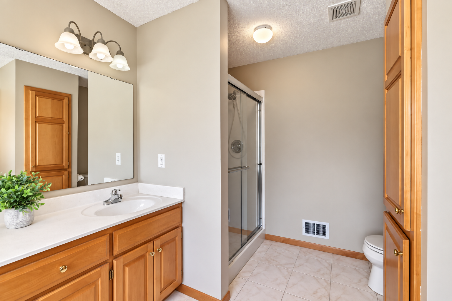 Separate shower and tile flooring in the primary bath.