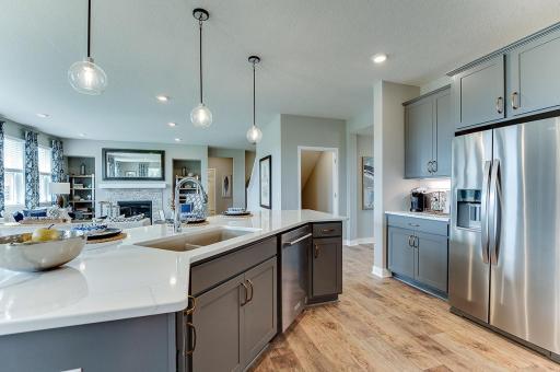 The kitchen's 12' island anchors your main level. Photo of model, colors and finishes vary.