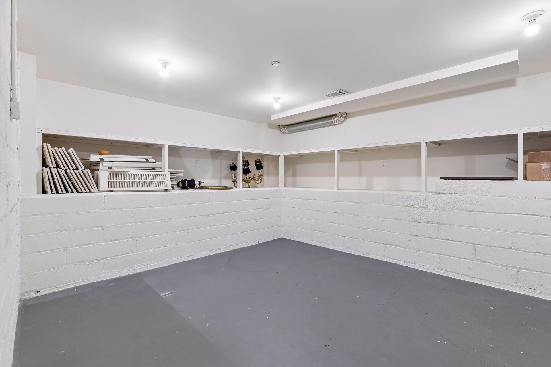 Light, bright, and organized storage rooms. This is one of four storage rooms on the lower level. Plenty of room for household storage and a wine cellar. A wine refrigerator is included in the sale.