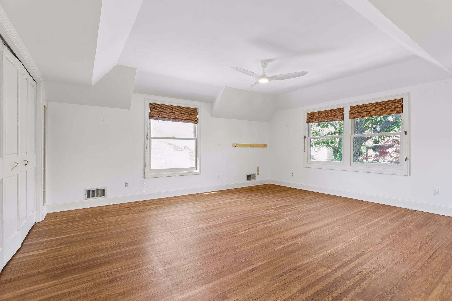 Spacious second bedroom with gorgeous hardwood floors and a double-door closet.