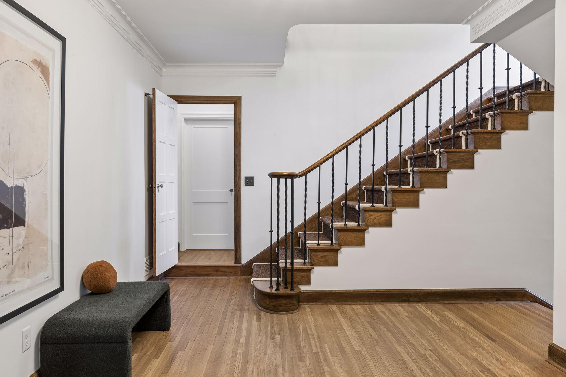 Front entry hall with nearby walk-in coat closet and discreet powder room with its own lounge area.