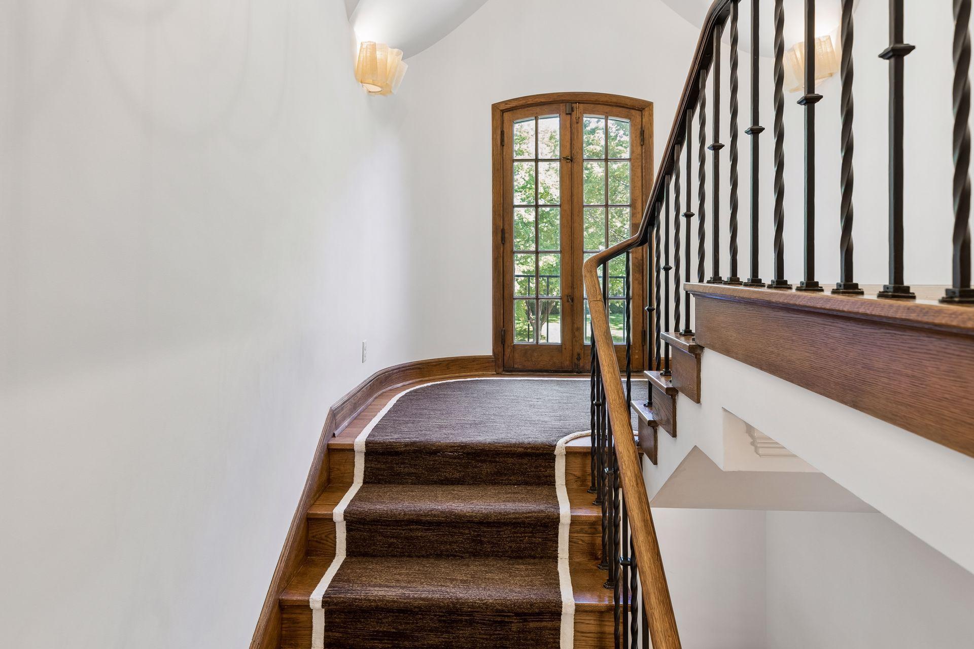 The beautifully crafted staircase leads to an upper landing with French doors to a Juliet balcony.