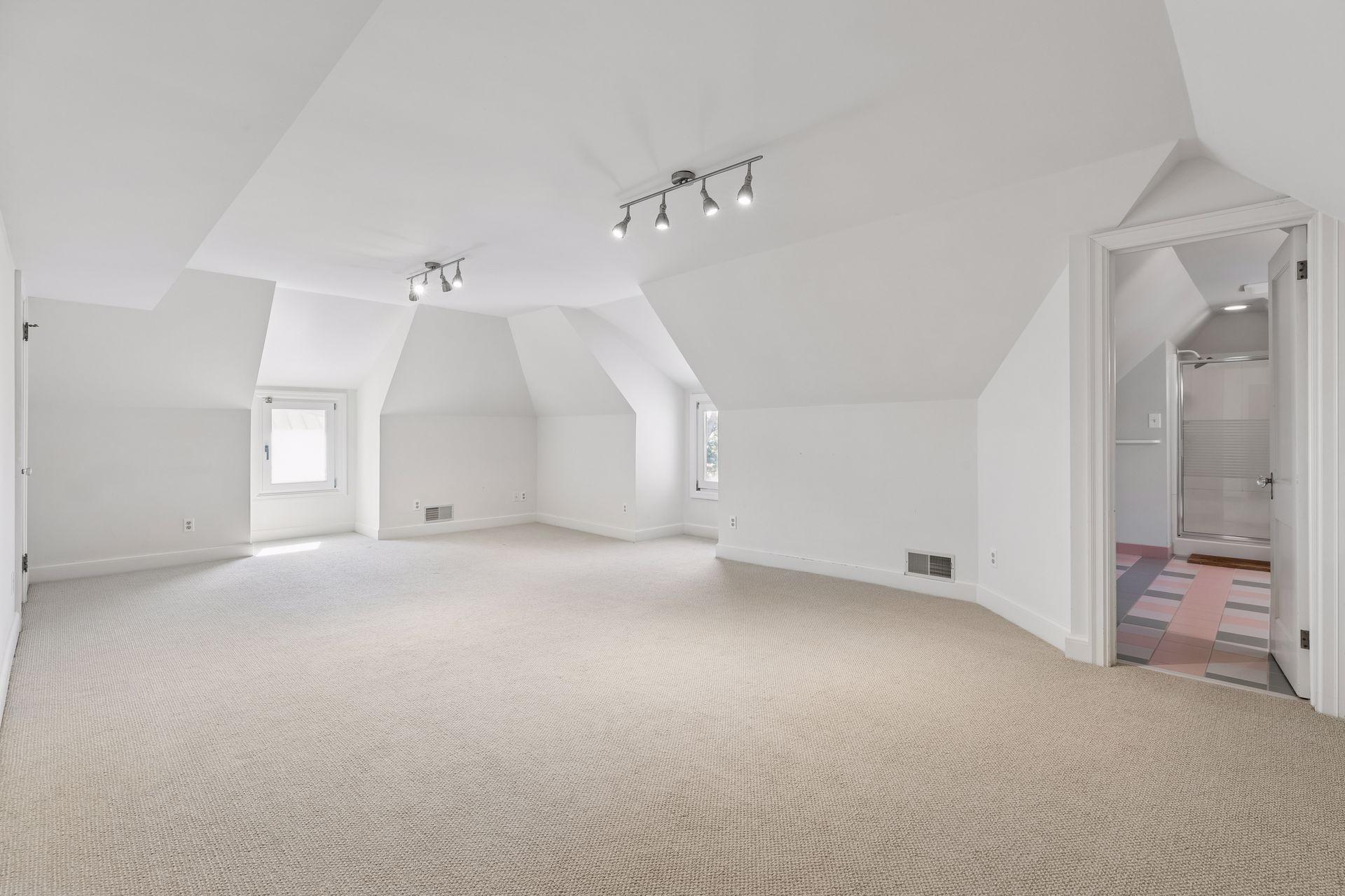 Third level bedroom suite with its own 3/4 bathroom and walk-in closet: a perfect bonus room, guest suite, nanny suite, or teen retreat.A hallway outside the bedrooms is spacious enough for a desk and leads to additional storage.