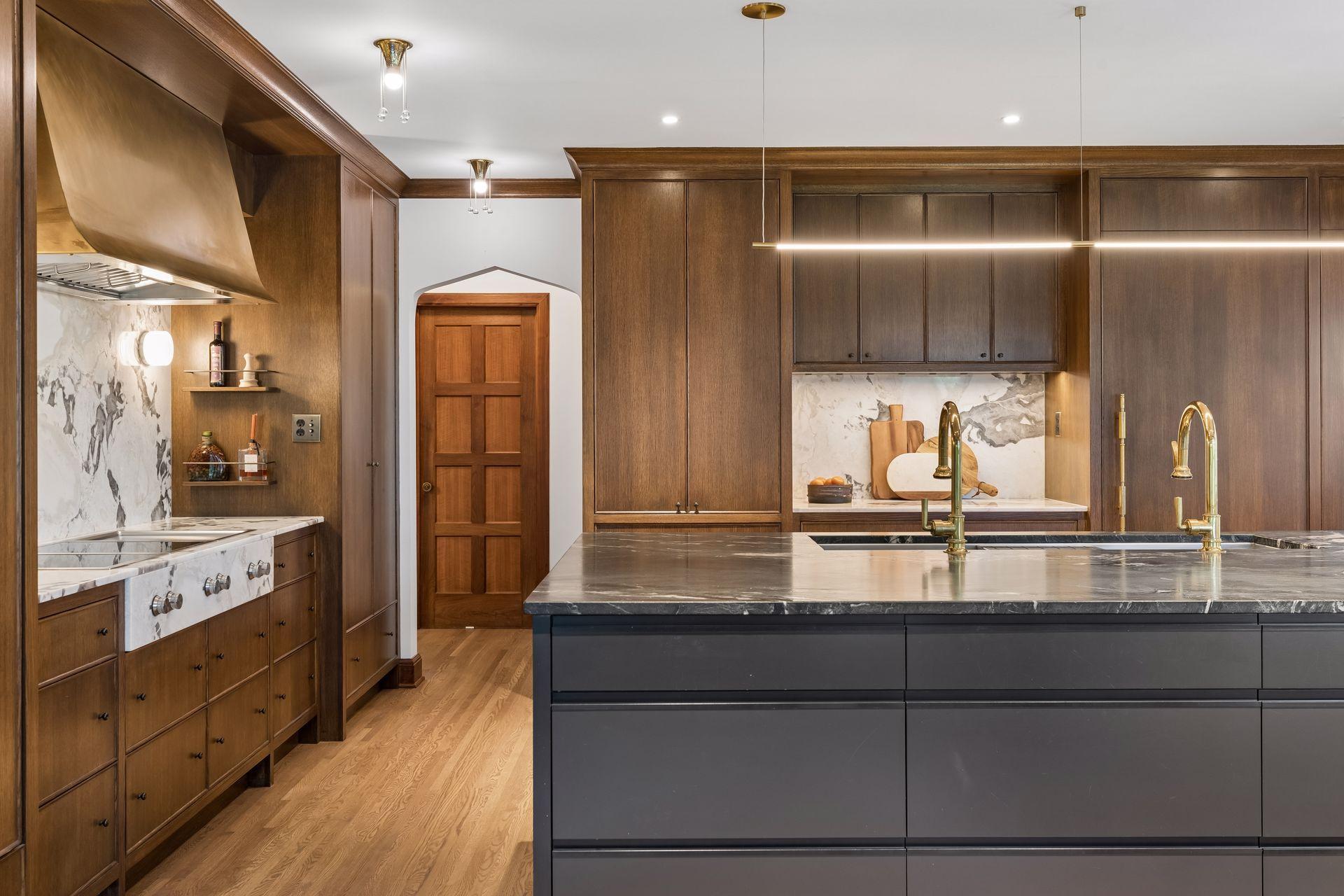 Abundant storage throughout the kitchen. Concealed double ovens, coffee bar, and pantry cupboard.