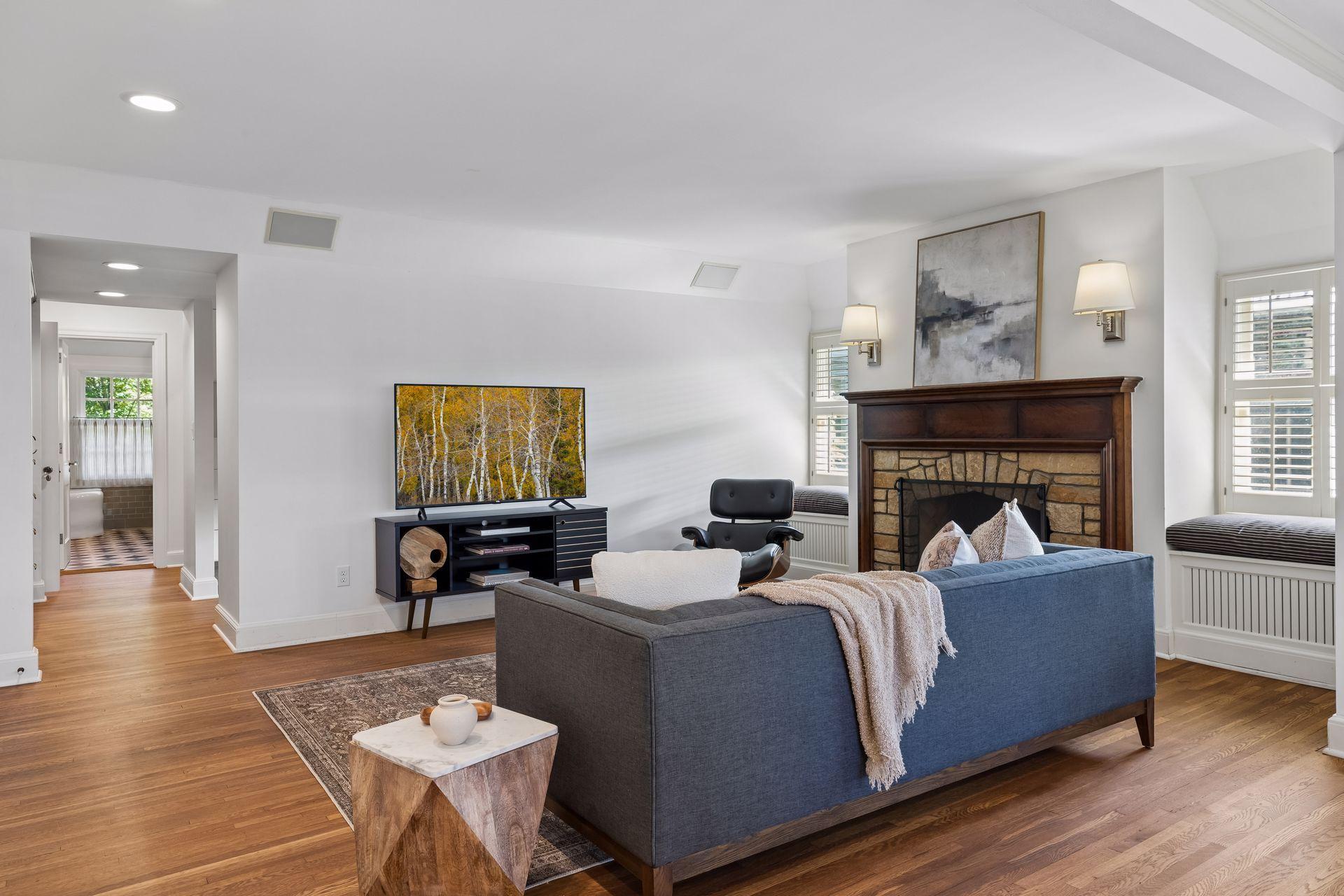 The primary suite sitting room includes access to the central hall making it an easy option as an additional bedroom, as needed, and a cozy private family room space.