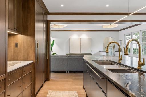The kitchen is open to the adjacent family room, sunroom with direct access to the patio and yard.