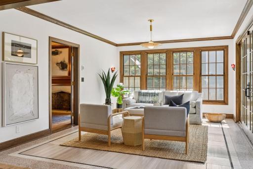 The sunny and bright sunroom features heated tile and terrazzo floors, lovely views of the yard and direct access through French sliding doors to the patio. An inviting space for every living thing!