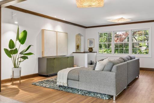 Two custom painting panels were designed to conceal the television. They slide apart on a smooth track for morning news, movie nights, and game days!